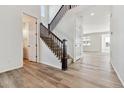 Bright entryway with hardwood floors, staircase, and half bathroom at 674 Penn Rd, Elizabeth, CO 80107