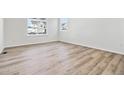 Spacious living room featuring hardwood floors and large windows at 674 Penn Rd, Elizabeth, CO 80107