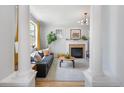 Bright living room featuring a fireplace, hardwood floors, and stylish modern decor at 3171 Fulton St, Denver, CO 80238