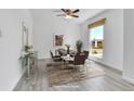 Bright dining room featuring a modern table set, natural light from a large window, and light wood floors at 1759 Cedar St, Broomfield, CO 80020