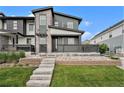 Modern two-story home featuring stone accents, a front porch, and well-maintained landscaping at 2054 S Upham Way, Denver, CO 80227