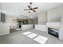 Open-concept living area with fireplace seamlessly connected to modern kitchen and a breakfast bar at 9434 Ashbury Cir # 203, Parker, CO 80134