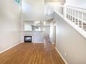 Spacious living room with hardwood floors, fireplace, and staircase to the second floor at 441 Grey Swallow St, Brighton, CO 80601