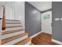 Cozy entryway featuring hardwood floors, neutral paint, stairway, and access to the main living area at 1346 S Grant St, Longmont, CO 80501
