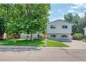 Traditional home with well-kept lawn, mature shade tree, painted brick, and welcoming curb appeal at 1346 S Grant St, Longmont, CO 80501