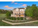 Back exterior view featuring a spacious yard, patio, and landscaping at 4704 Cedar Glen Pl, Castle Rock, CO 80109