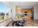 Cozy breakfast nook with stainless steel appliances and wood cabinets at 4704 Cedar Glen Pl, Castle Rock, CO 80109
