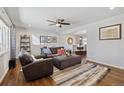 Bright living room features hardwood floors, ceiling fan and seamless flow to the dining area at 9290 N Raleigh St, Westminster, CO 80031