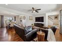 Inviting living room with hardwood floors, modern ceiling fan, and view to dining area at 9290 N Raleigh St, Westminster, CO 80031