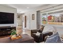 Comfortable living room with hardwood floors, TV, and a view of the front entry at 9290 N Raleigh St, Westminster, CO 80031