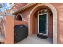 Townhome's front entrance with security door and exterior lighting at 13953 E Princeton Pl # B, Aurora, CO 80014