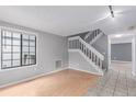 Bright living room with a staircase, light hardwood floors, and a large window at 9328 Fenton Ct, Westminster, CO 80031