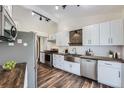 Bright kitchen with stainless steel appliances, white cabinetry, and a stylish backsplash at 13805 W 82Nd Ave, Arvada, CO 80005