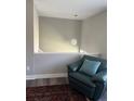 Comfortable loft area with chair, accent pillow, and hanging light fixture at 1477 S Wright Ct, Lakewood, CO 80228