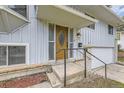 Detailed front entry showcasing a decorative wood door with glass accents and brick detailing at 1477 S Wright St, Lakewood, CO 80228