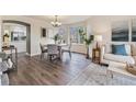 Bright dining room featuring a modern chandelier, a bay window, and stylish decor at 6876 Edgewood Way, Highlands Ranch, CO 80130