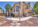 Charming two-story home with a well-manicured front yard and a stone walkway at 4560 Flanders Way, Denver, CO 80249