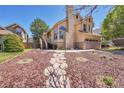 Charming two-story home with a well-manicured front yard and a stone walkway at 4560 Flanders Way, Denver, CO 80249