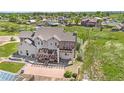 Backyard view of the home, pergola, patio, and surrounding green spaces at 7587 Wright Ct, Arvada, CO 80005