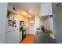 Efficient kitchen featuring white cabinets, black appliances, and a stainless steel sink at 865 S Quebec St # 302A, Denver, CO 80247