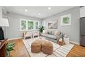 Open-concept living room featuring hardwood floors, bright windows, and modern furniture at 635 Fillmore St, Denver, CO 80206