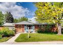 Charming single-story brick home with lush green lawn and freshly landscaped front yard at 7005 S Ash Cir, Centennial, CO 80122