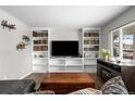 Comfortable living room with custom built-in shelving and entertainment center at 31 W Fremont Ave, Littleton, CO 80120