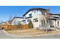 Contemporary home featuring a stone facade and a fenced yard at 65 Newport St, Denver, CO 80230
