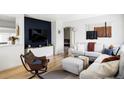 Cozy living room with a modern accent wall, hardwood floors, and comfortable seating at 873 S Raritan St, Denver, CO 80223