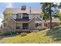 Two-story home with stone accents and a large deck at 12421 High Country Trl, Littleton, CO 80127