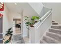 Bright entryway with stairs leading upstairs, showcasing light flooring at 15983 E Warner Dr, Denver, CO 80239