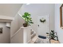 Front entry featuring a staircase and neutral color palette at 15983 E Warner Dr, Denver, CO 80239