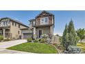 Two-story house with gray siding, stone, and a basketball hoop at 15983 E Warner Dr, Denver, CO 80239