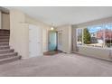 Bright living room with carpet floors and large window for natural light at 9960 Kline St, Broomfield, CO 80021
