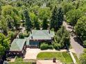 Expansive aerial view of home featuring lush landscaping, a green tile roof, and a spacious driveway at 2215 E 7Th Avenue Pkwy, Denver, CO 80206