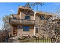 Stylish two-story house with balcony, modern facade, complemented by a charming front yard area at 3323 W Hayward Pl, Denver, CO 80211