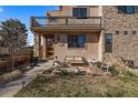 Beautiful two-story home showcasing a balcony, stone accents, and a welcoming front yard seating area at 3323 W Hayward Pl, Denver, CO 80211