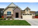 Charming single-Gathering home showcasing a brick entrance, a two-car garage, and verdant landscaping at 10185 Isle St, Parker, CO 80134