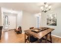 Charming dining room with natural light, hardwood floors, and a cozy bench by the front door at 9411 W 89Th Cir, Westminster, CO 80021