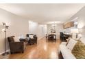 Inviting living room features gleaming wood floors, comfortable seating, and a decorative fireplace, ideal for relaxation at 9411 W 89Th Cir, Westminster, CO 80021