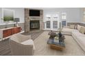 Comfortable living room with stone fireplace and neutral decor, creating a relaxing atmosphere at 19618 Rosewood Ct, Parker, CO 80138