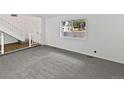 This large, empty living room has new paint and updated carpet at 3661 S Joplin St, Aurora, CO 80013