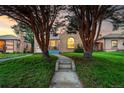 Charming brick home framed by mature trees, with a welcoming walkway leading to the entrance at 2745 N Saint Paul St, Denver, CO 80205
