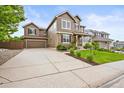 View of the exterior with a large driveway and a two-car garage attached to the right of the house at 10235 Rustic Redwood Ln, Highlands Ranch, CO 80126