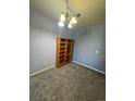 Cozy bedroom with neutral carpeting, a light fixture, and a nice-sized closet at 1425 Blue Sky Cir # 15-204, Erie, CO 80516