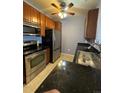Well-equipped kitchen with stainless steel appliances, dark countertops, and ample cabinet space at 1425 Blue Sky Cir # 15-204, Erie, CO 80516