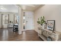 Inviting entryway with dark wood flooring, a decorative console table, and a view into the adjacent living space at 22870 E Chenango Ave, Aurora, CO 80015
