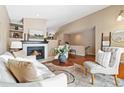 Spacious living room with hardwood floors and fireplace at 25 Canongate Ln, Highlands Ranch, CO 80130