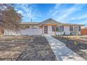 Attractive single-story home with a well-maintained yard and inviting front walkway at 6909 S Clermont St, Centennial, CO 80122