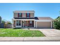 Attractive two-story home features a two-car garage, brick accents, and a well-maintained lawn at 714 Sedge Way, Lafayette, CO 80026